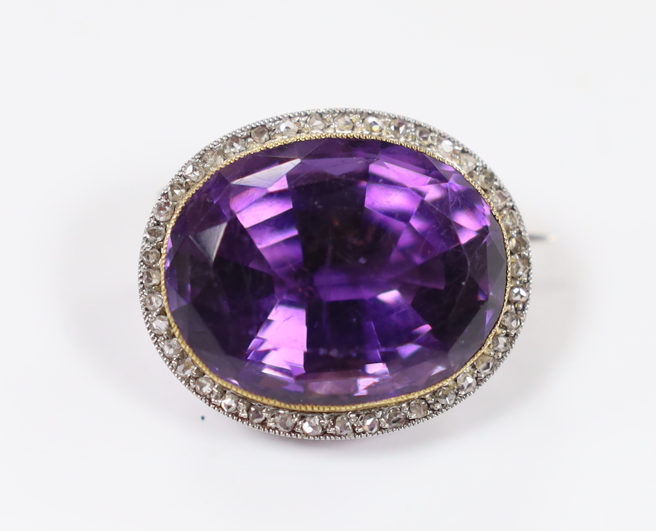 An early 20th century yellow and white metal, amethyst and rose cut diamond set oval cluster set brooch, 26mm, gross weight 11.2 grams.